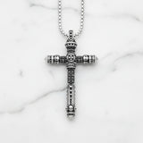 Silver Skull cross pendant necklace on a textured gray background 