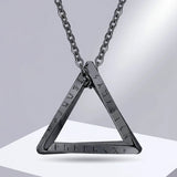 Triangular pendant necklace with engraved text on a gray background