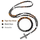 Necklace with tiger eye, black onyx, and hematite beads and a cross pendant on a white background.