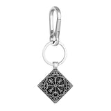 Silver keychain with a black geometric design on a white background
