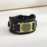 Black leather bracelet with a gold Vegvisir symbol on a white background