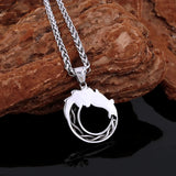 Silver necklace with a pendant back side view  on a dark surface