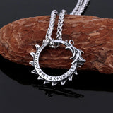 Silver pendant necklace on a dark background