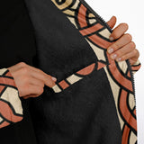 Close-up of a person wearing a black fuzzy zip jacket with a beige and terracotta abstract patterned lining and cuffs, showing hands opening the zipper.