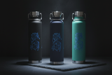 Three insulated water bottles with a dragon design on a dark background